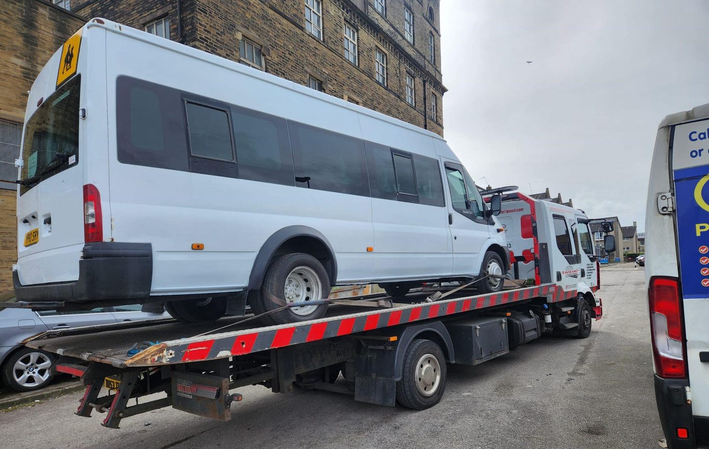 Minibus on a recovery truck